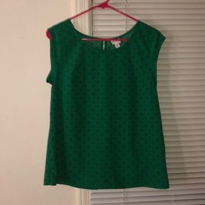 a green shirt with floral design